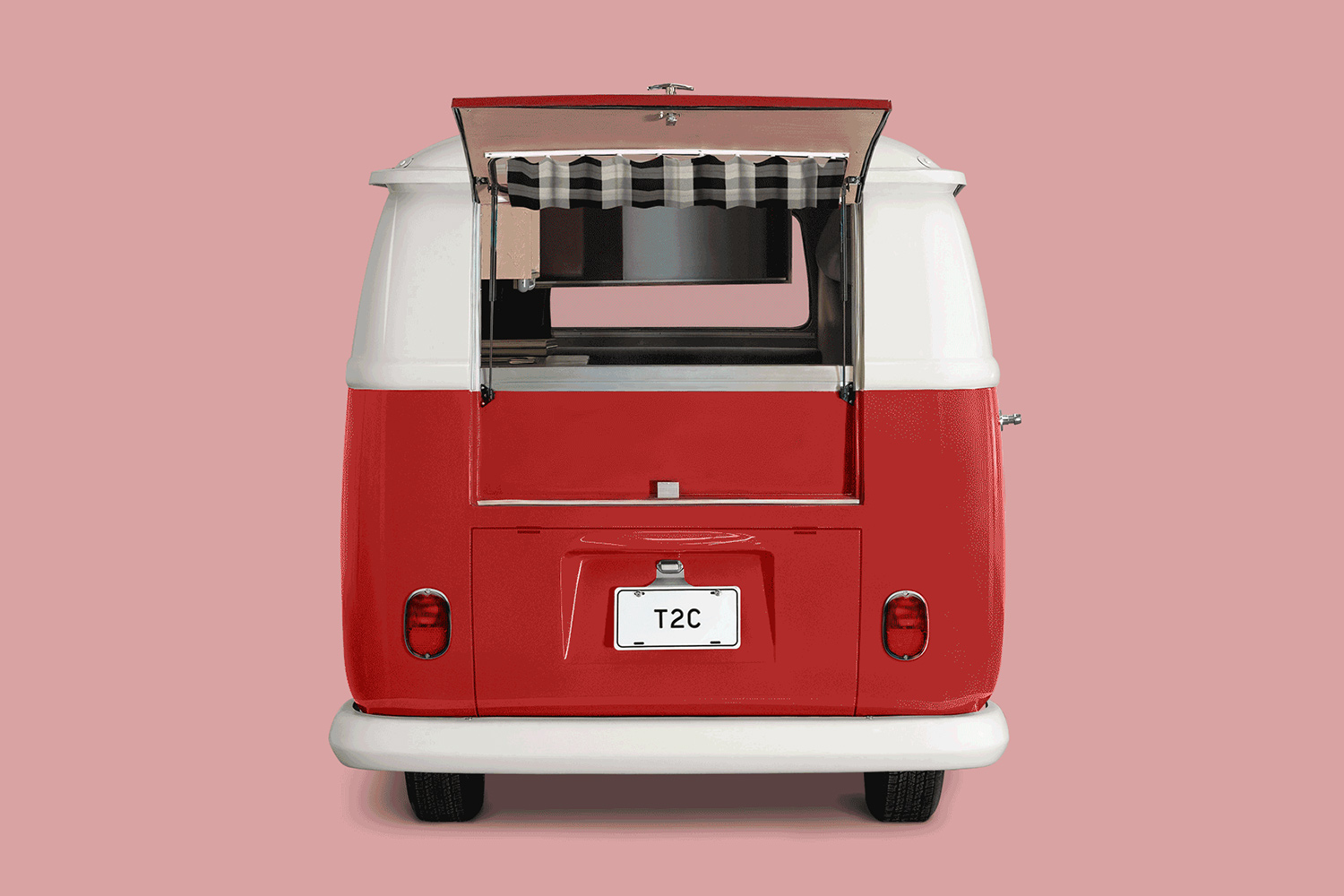 A red Model T2.3 camper from Type 2 Campers with the back window open