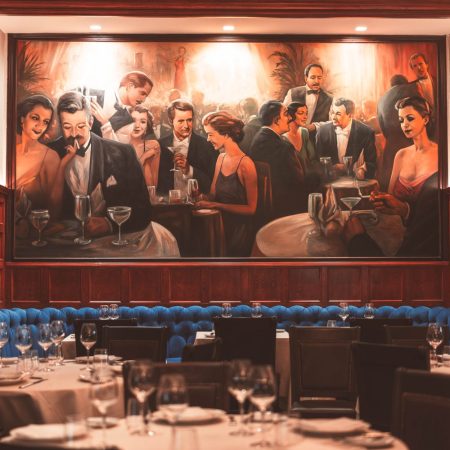 A large painting above at booth at Delmonico's, one of the oldest restaurants in NYC