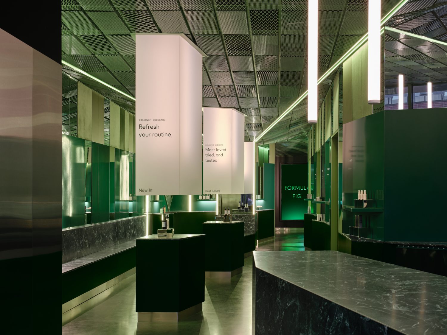 inside of bathroom, marble sink, green interior, light up lamps with words on them 