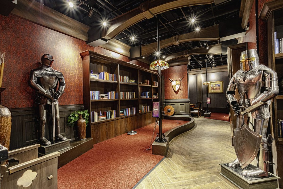 two knight statues in armor, mini golf, red carpet, book shelves with books, lamps
