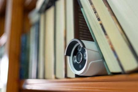 A camera in a bookshelf. Airbnb is updating its policy on indoor security cameras like this.