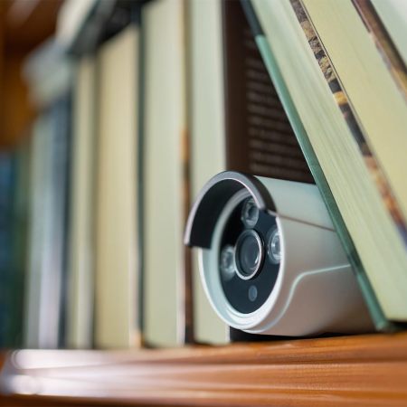 A camera in a bookshelf. Airbnb is updating its policy on indoor security cameras like this.