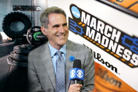 Broadcaster Seth Davis, flanked by gym equipment to his left and the March Madness logo to his right.