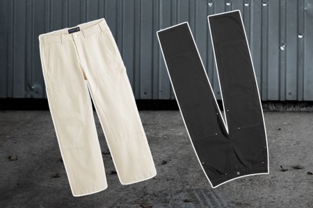 two pairs of workwear pants on a steel background
