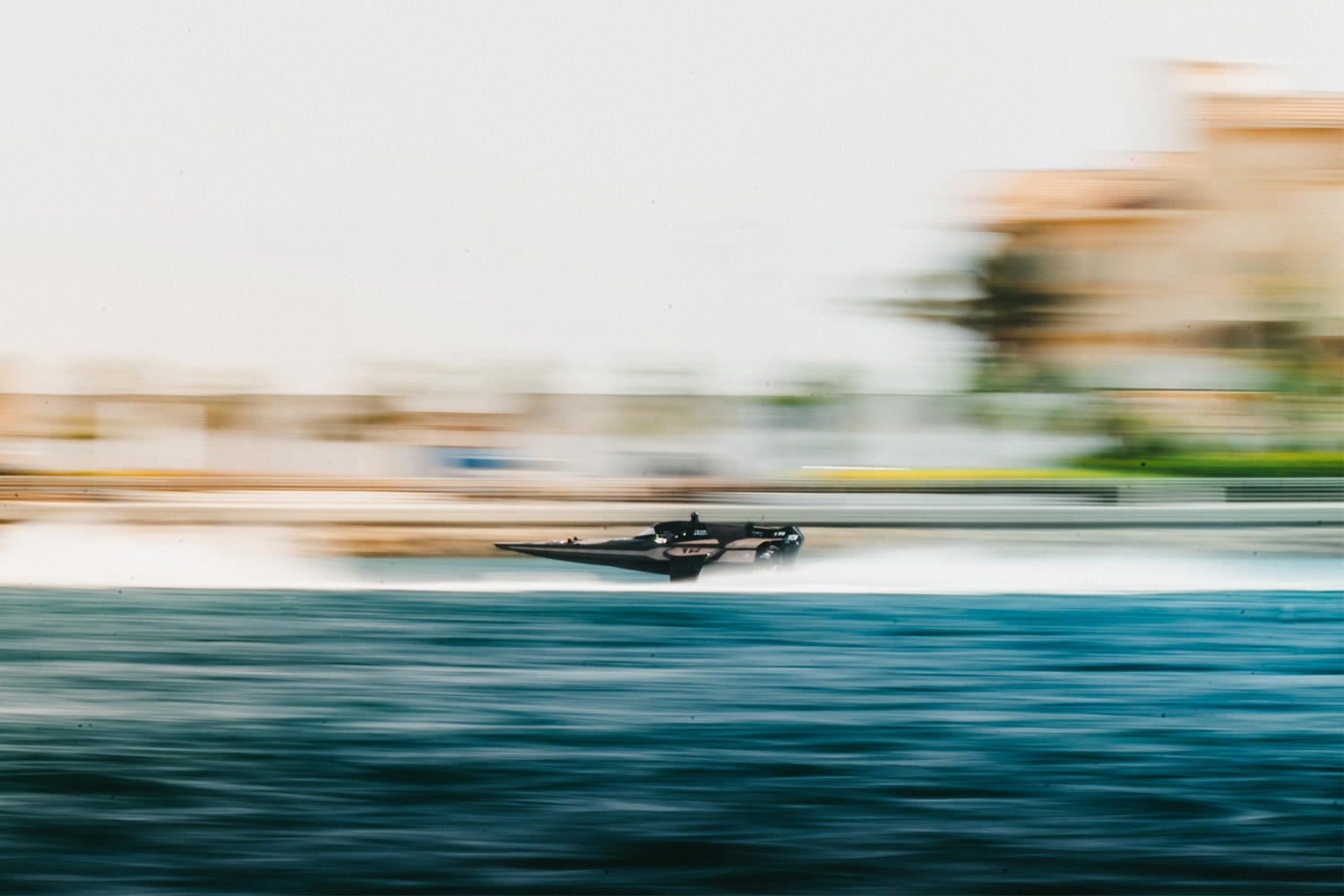 A blurry image of a powerboat racing across the water.