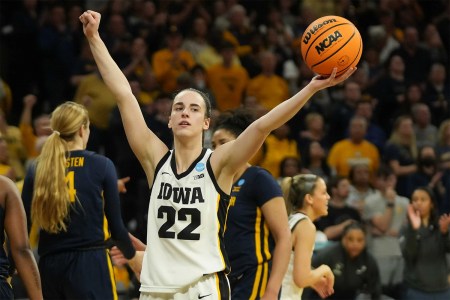 Caitlin Clark of the Iowa Hawkeyes hold a basketball up at an NCAA game. Ice Cube says he offered her $5 million to play in the Big3 league.
