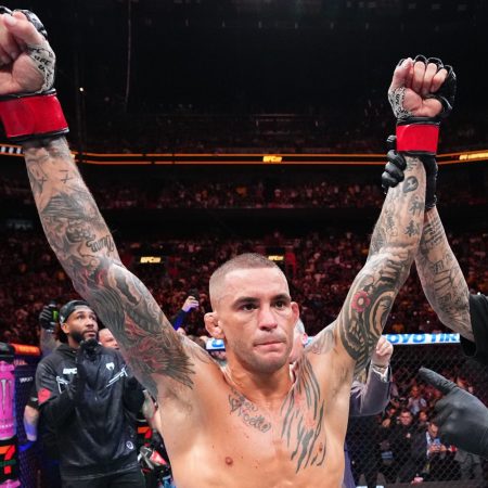 Dustin Poirier holds up his hands in victory.