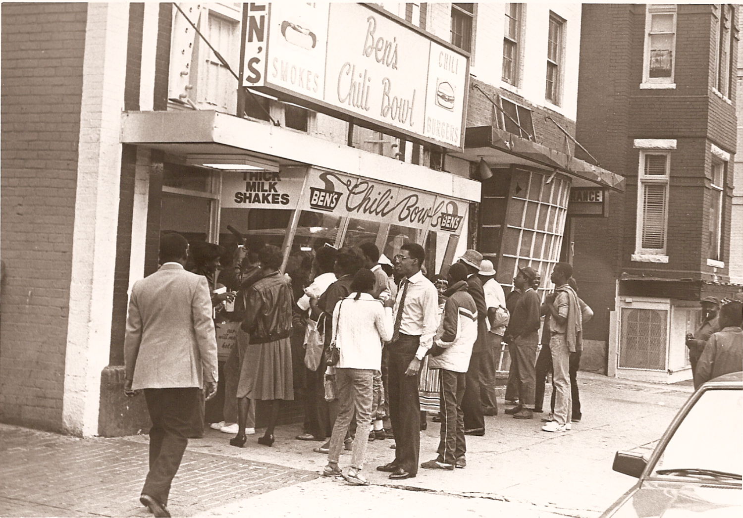 African Americans lining up in front of restaurant