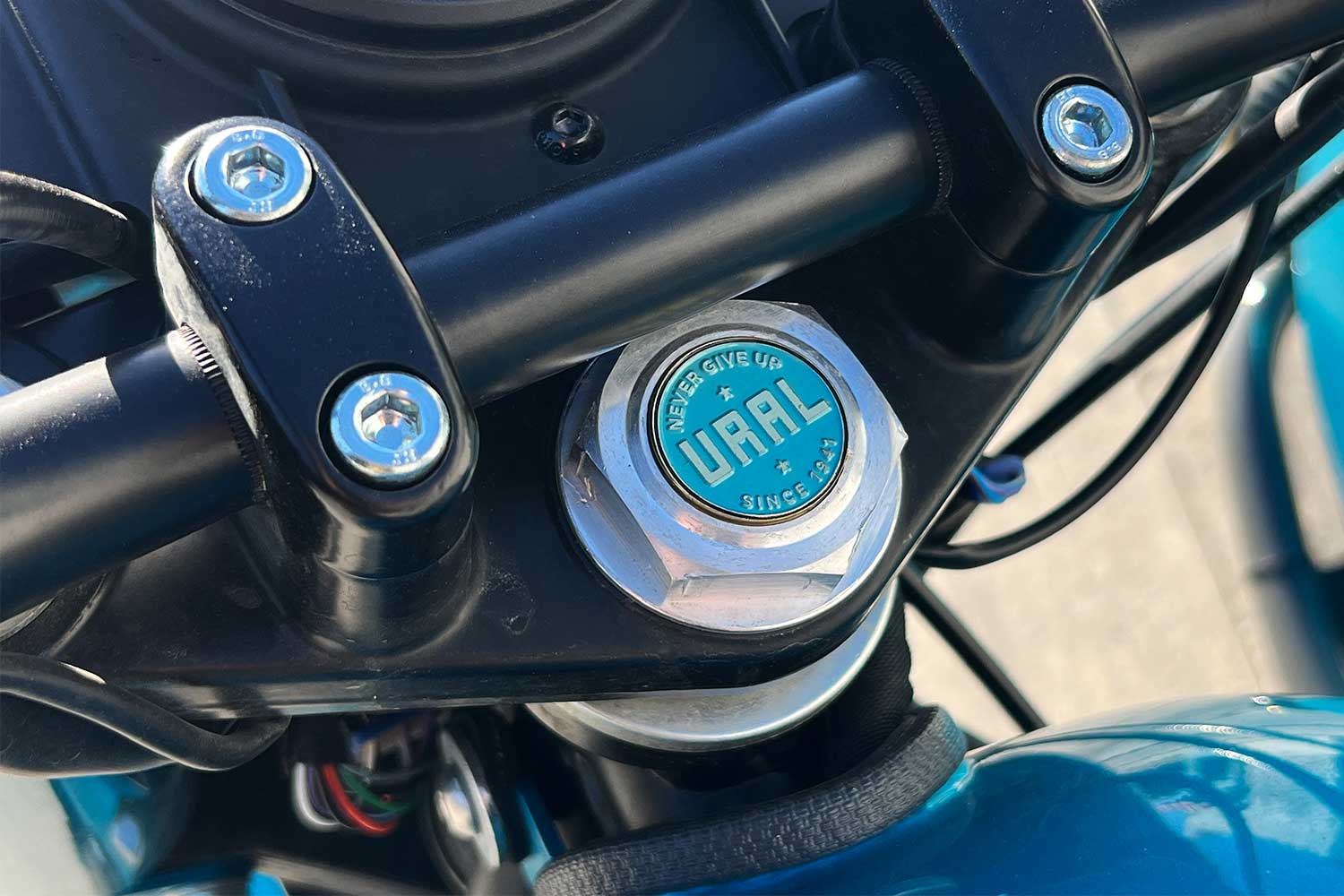 A bolt on a Ural sidecar motorcycle that reads "Never Give Up" and "Since 1941"