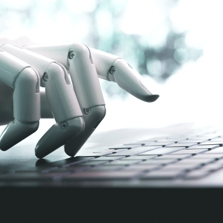 Robot hand on keyboard
