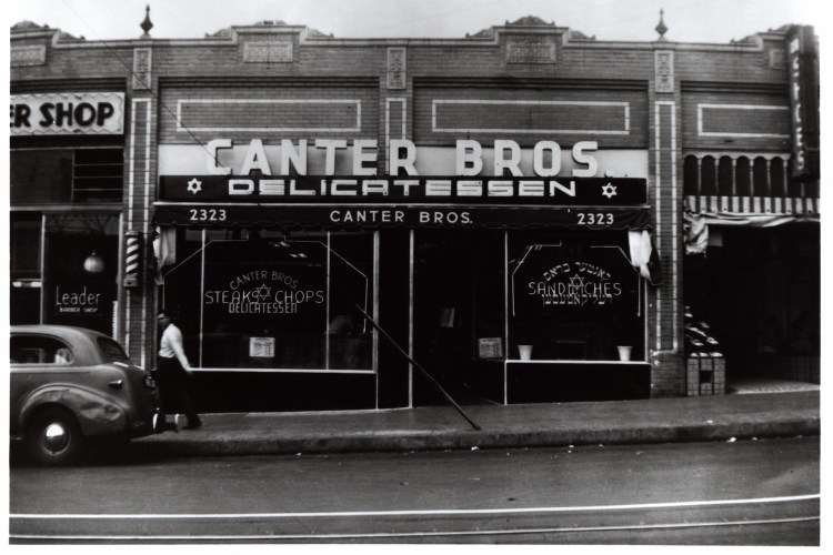 black and white vintage photo of restaurant front with sign