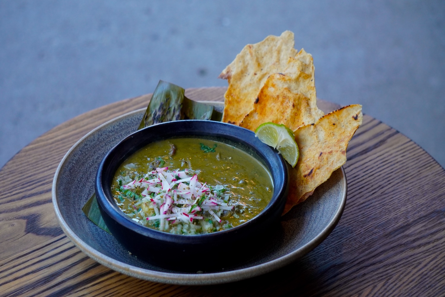 green soup with side of crispy tortilla