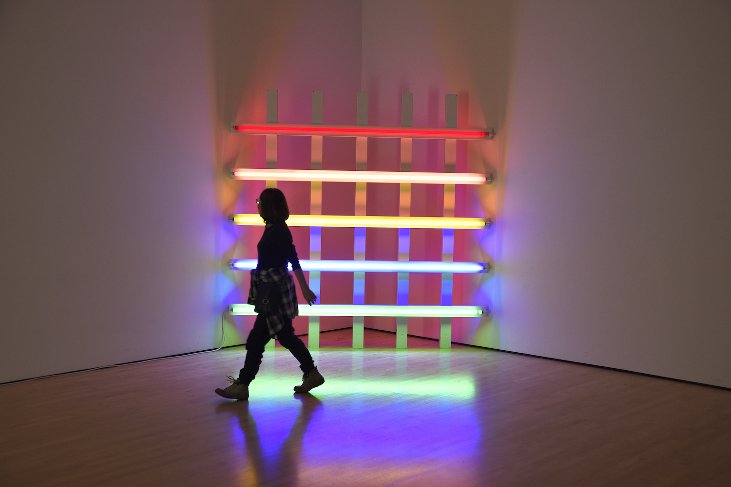 A museum visitor admires a neon sculpture by Dan Flavin at the San Francisco Museum of Modern Art in San Francisco, California