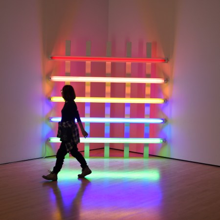 A museum visitor admires a neon sculpture by Dan Flavin at the San Francisco Museum of Modern Art in San Francisco, California