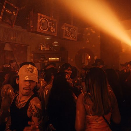 people dancing in a nightclub, orange dim lighting