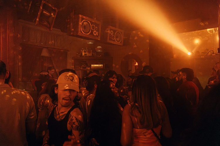 people dancing in a nightclub, orange dim lighting