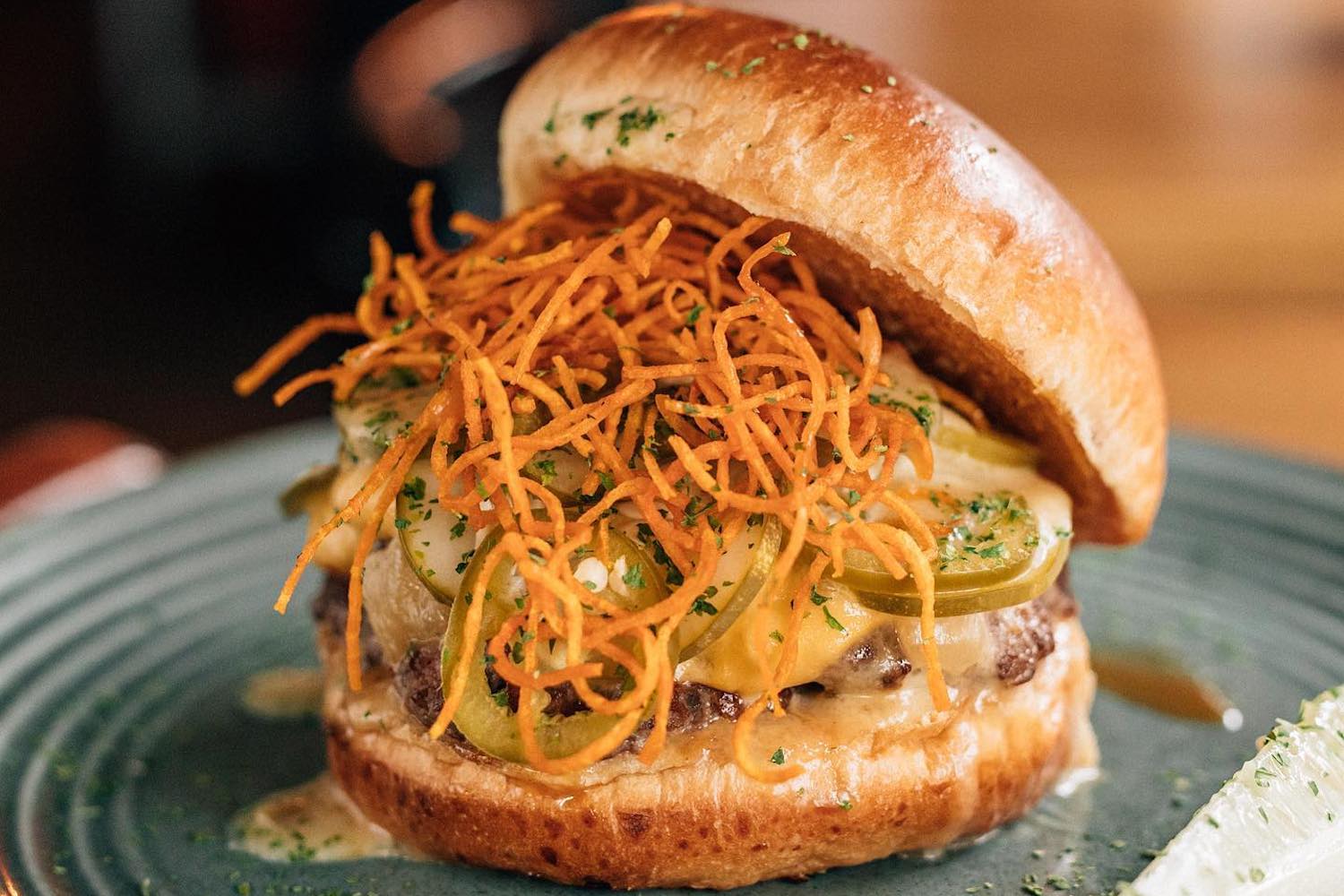 a burger topped with pickles and cheese