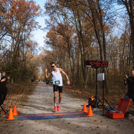 Charlie Lawrence crosses the finish line with a new 50-mile record.