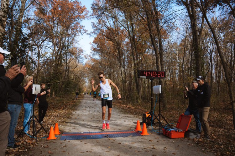 Charlie Lawrence crosses the finish line with a new 50-mile record.