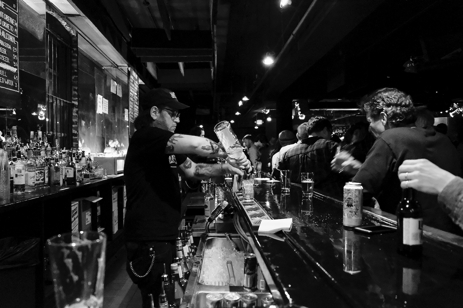 bartender pouring drink, black and white image,