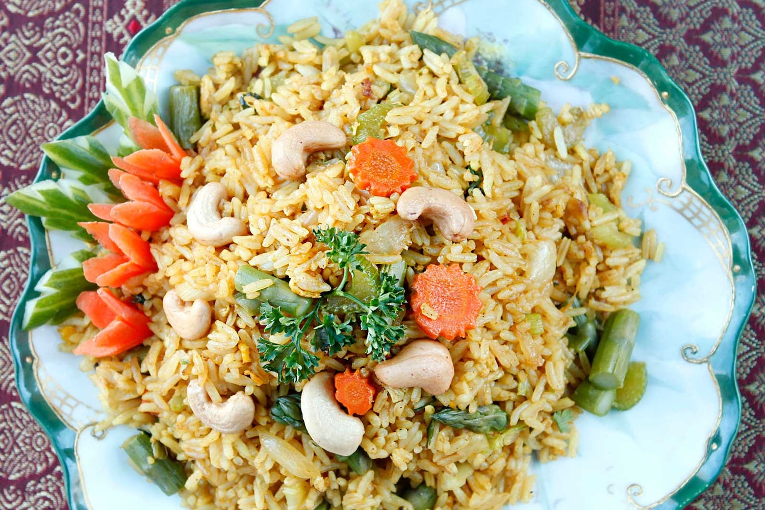 fried rice with carrots and peanuts on a blue plate