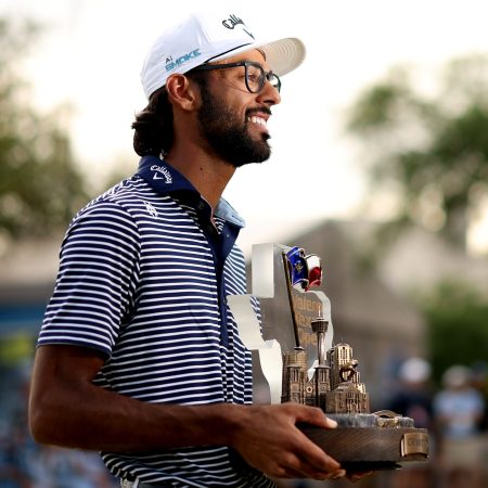 Akshay Bhatia poses with the trophy after winning the Valero Texas Open.