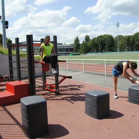 A group of people exercising at an outdoor fitness park.