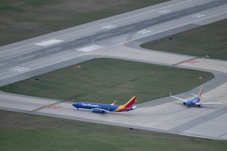 Southwest Airlines airplanes on the runway. A plane manufactured by Boeing had its engine cover rip off during takeoff.
