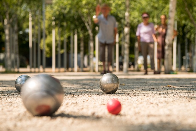 An angle of adults playing petanque in the summer. We take a look at the other international games to try this season.