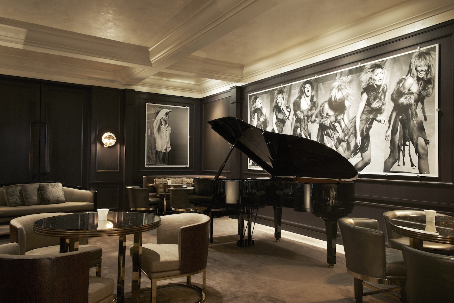 black and white photos of Tina Turner, black grand piano, silver seats and tables