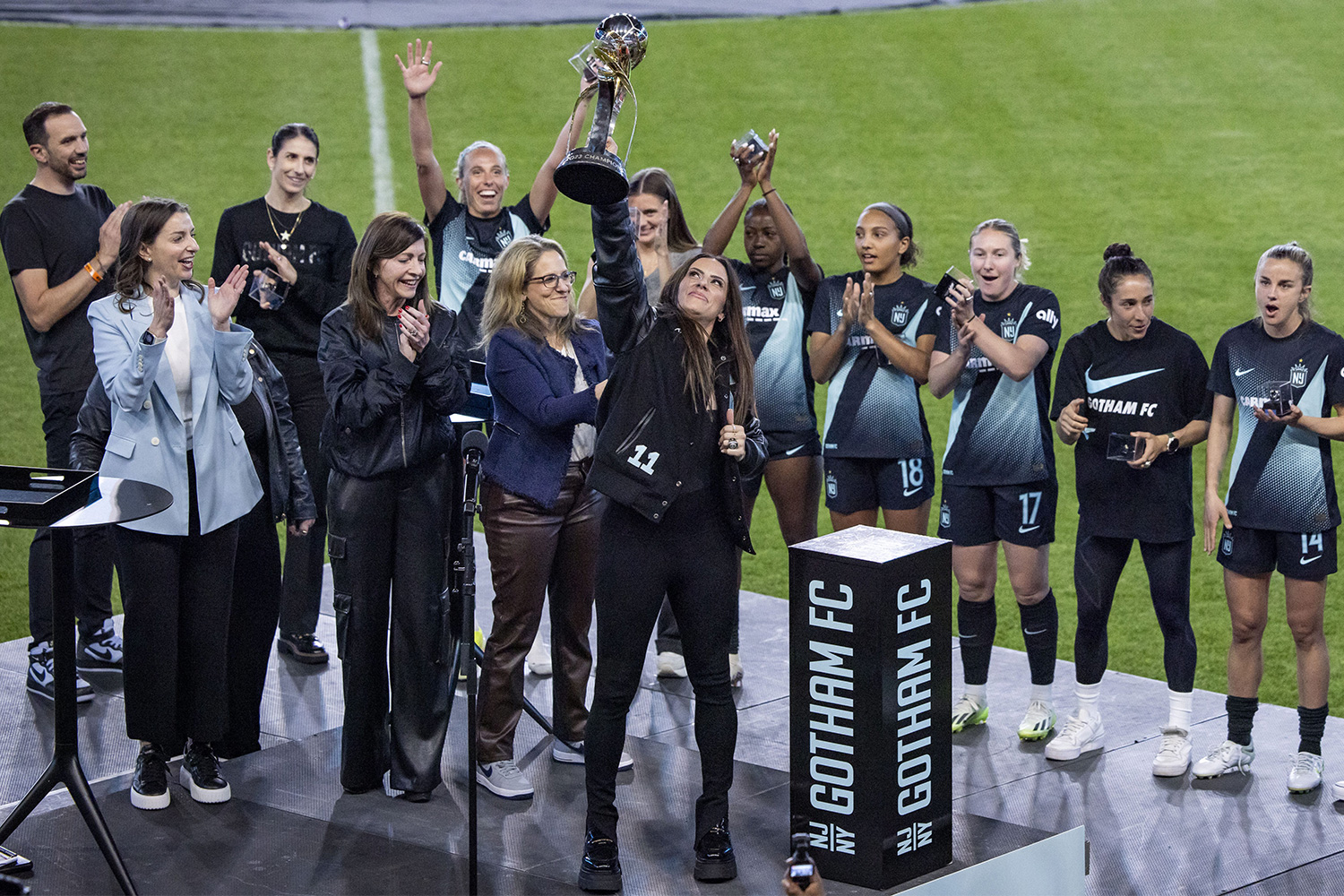 Members of Gotham FC celebrate with the NWSL Championship trophy.