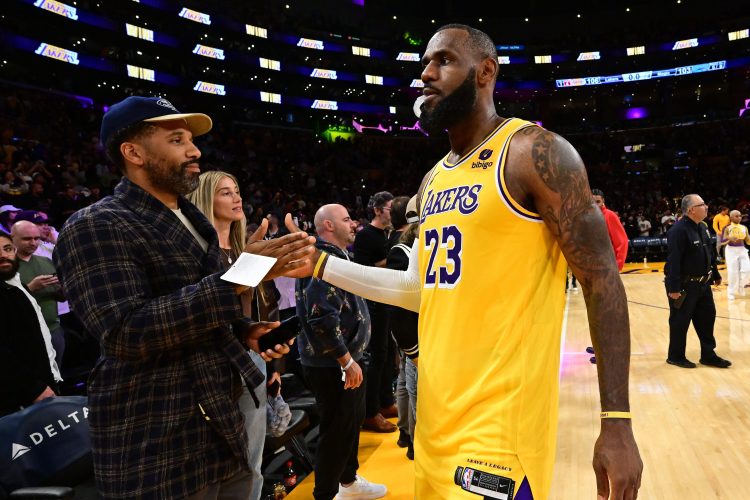 Maverick Carter high-fives LeBron James.