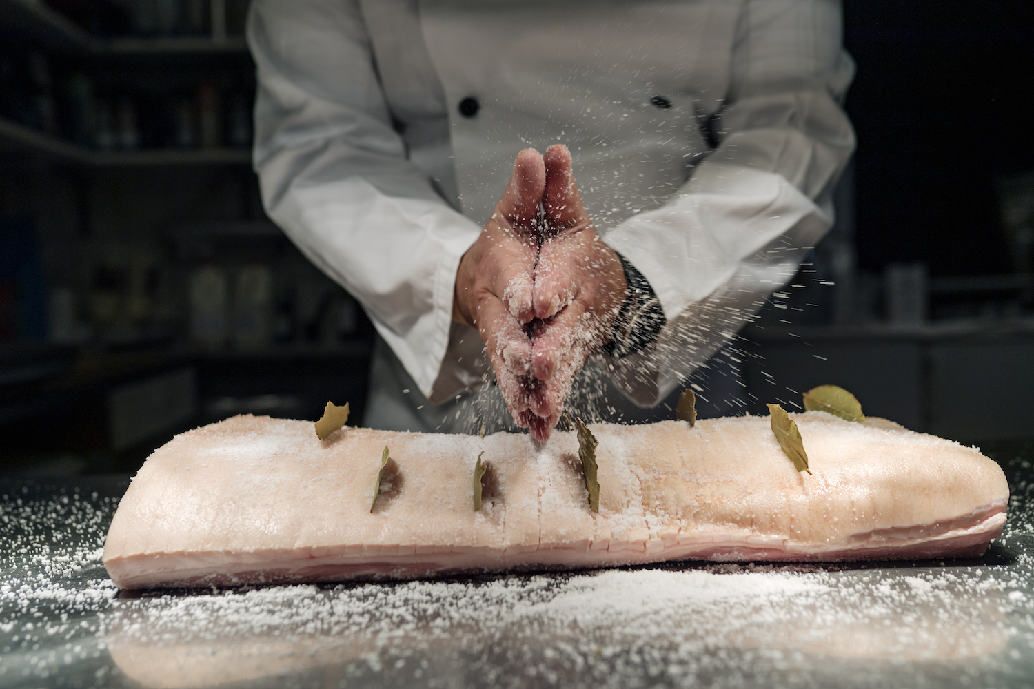 A pro chef salts the Danish dish flæskesteg, a celebratory roast pork