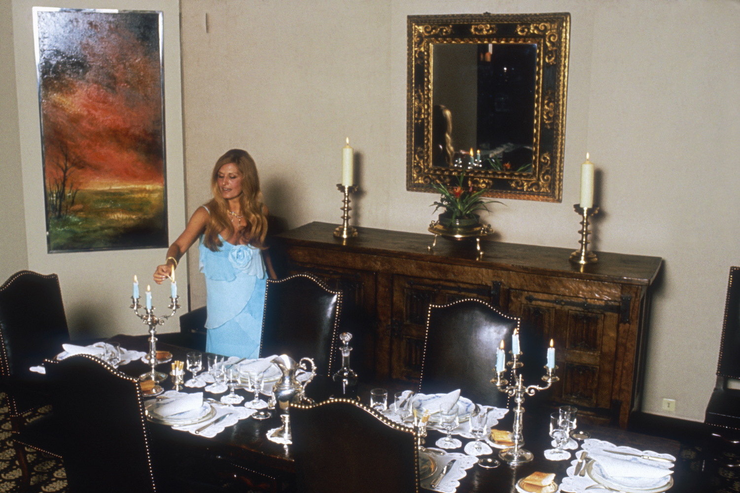 Egyptian-born singer Dalida lights the candles on her dinner table