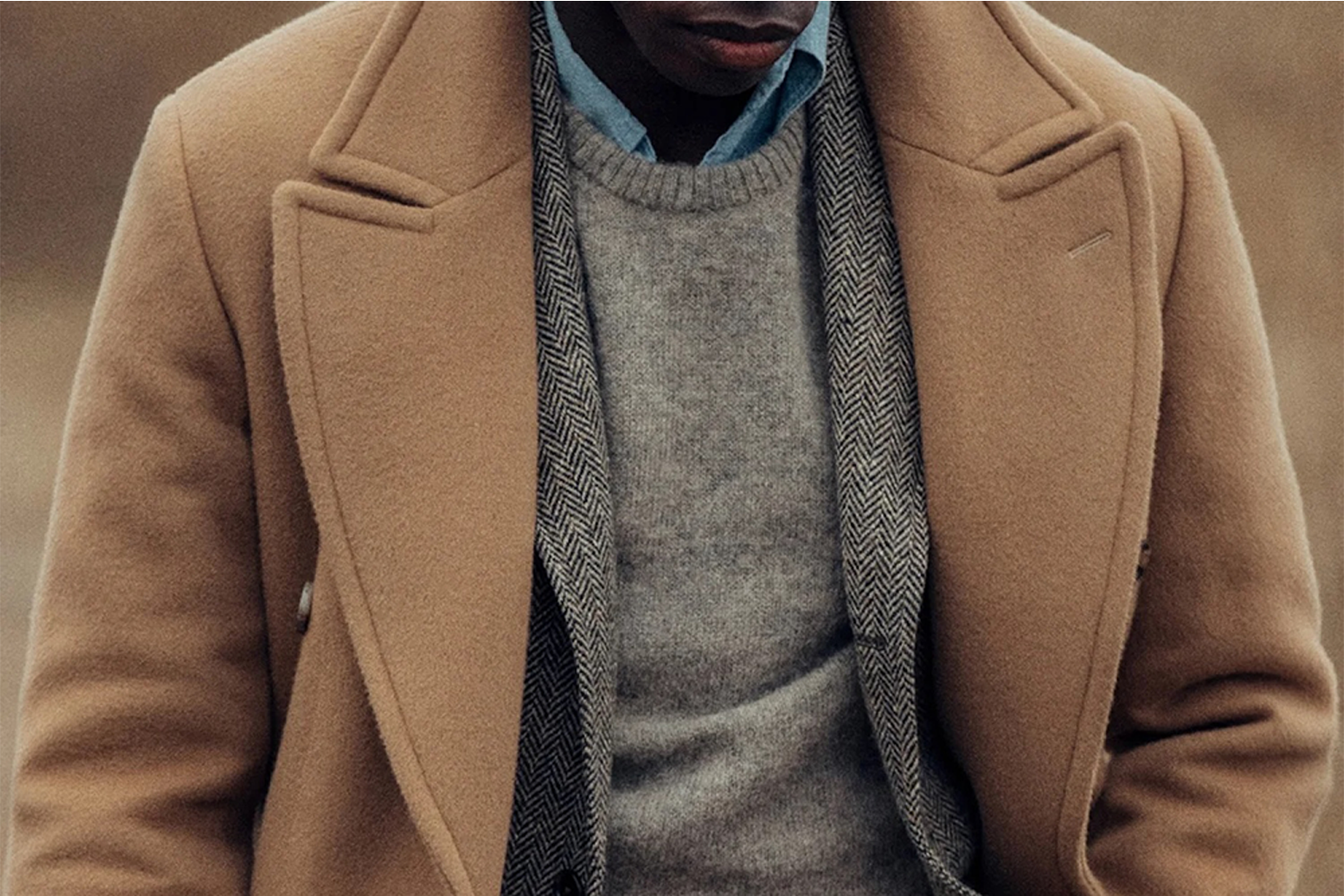 A man wearing a wool coat from Buck Mason