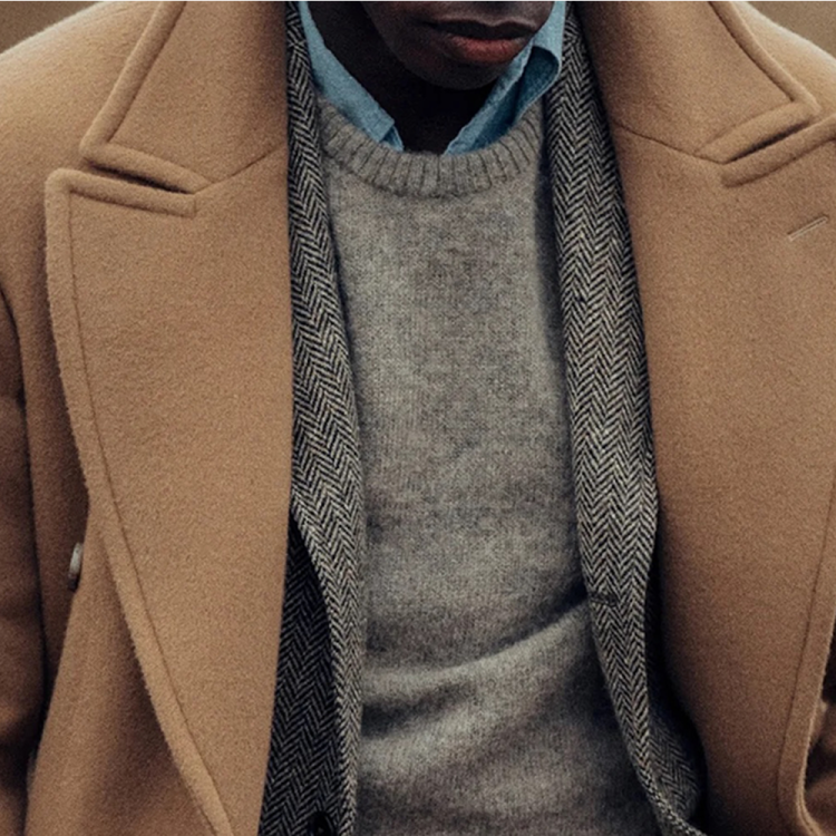 A man wearing a wool coat from Buck Mason