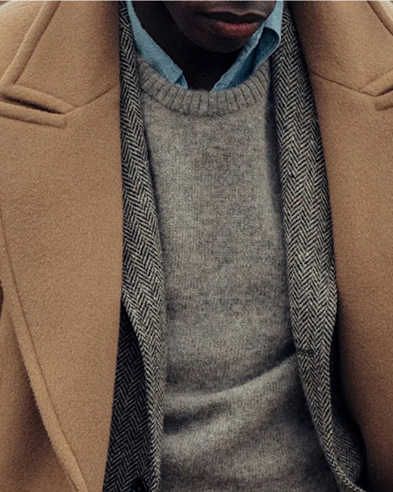 A man wearing a wool coat from Buck Mason