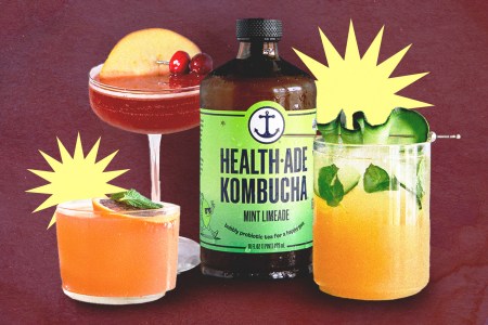 three cocktails next to a bottle of health-ade kombucha on a burgundy background