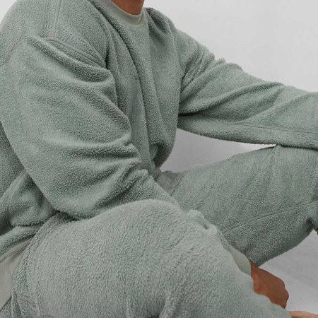 A model wearing Lunya's silksweats reversible sweatsuit