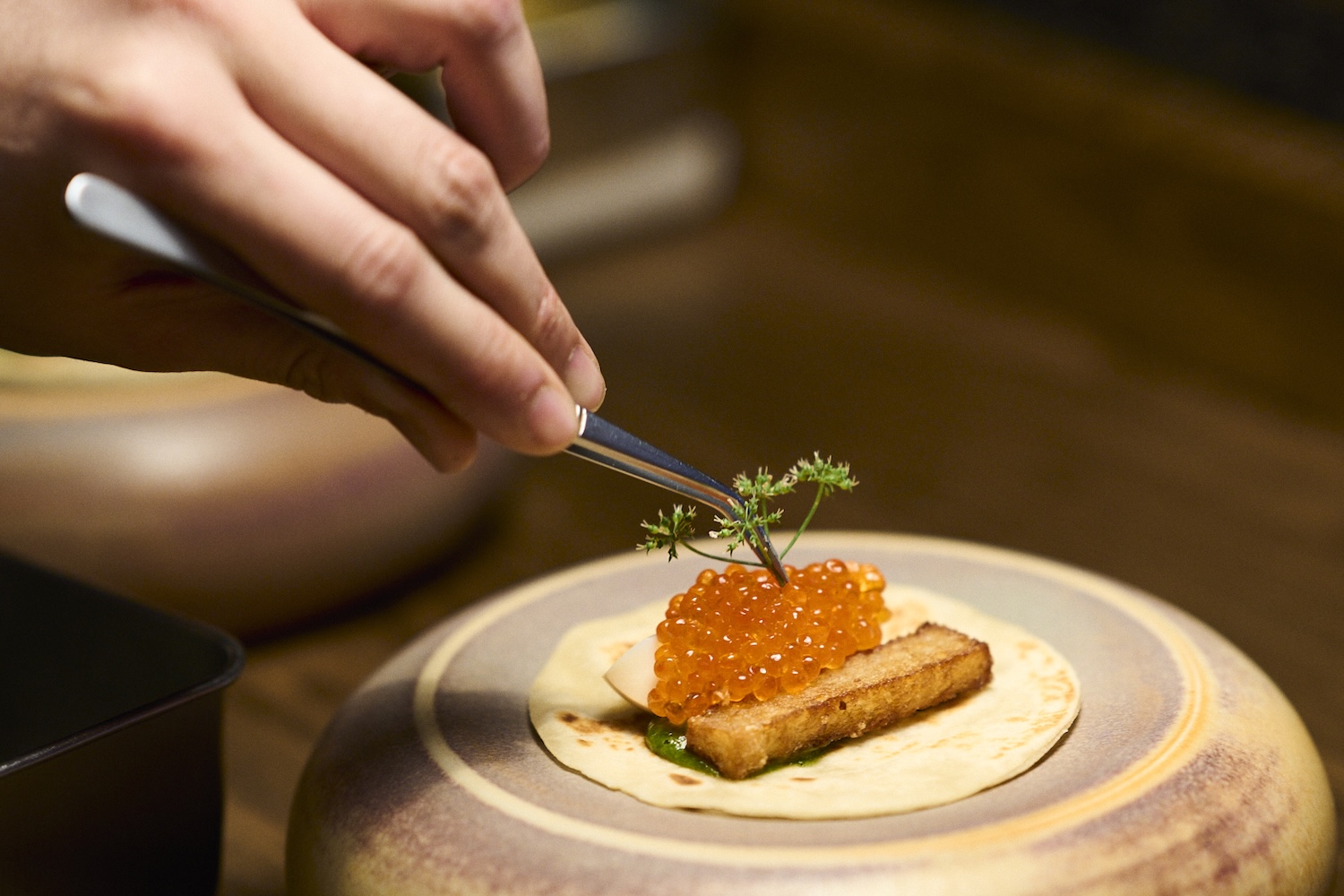 Person plating caviar