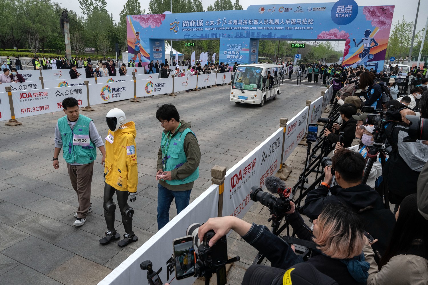 A robot running with two technicians