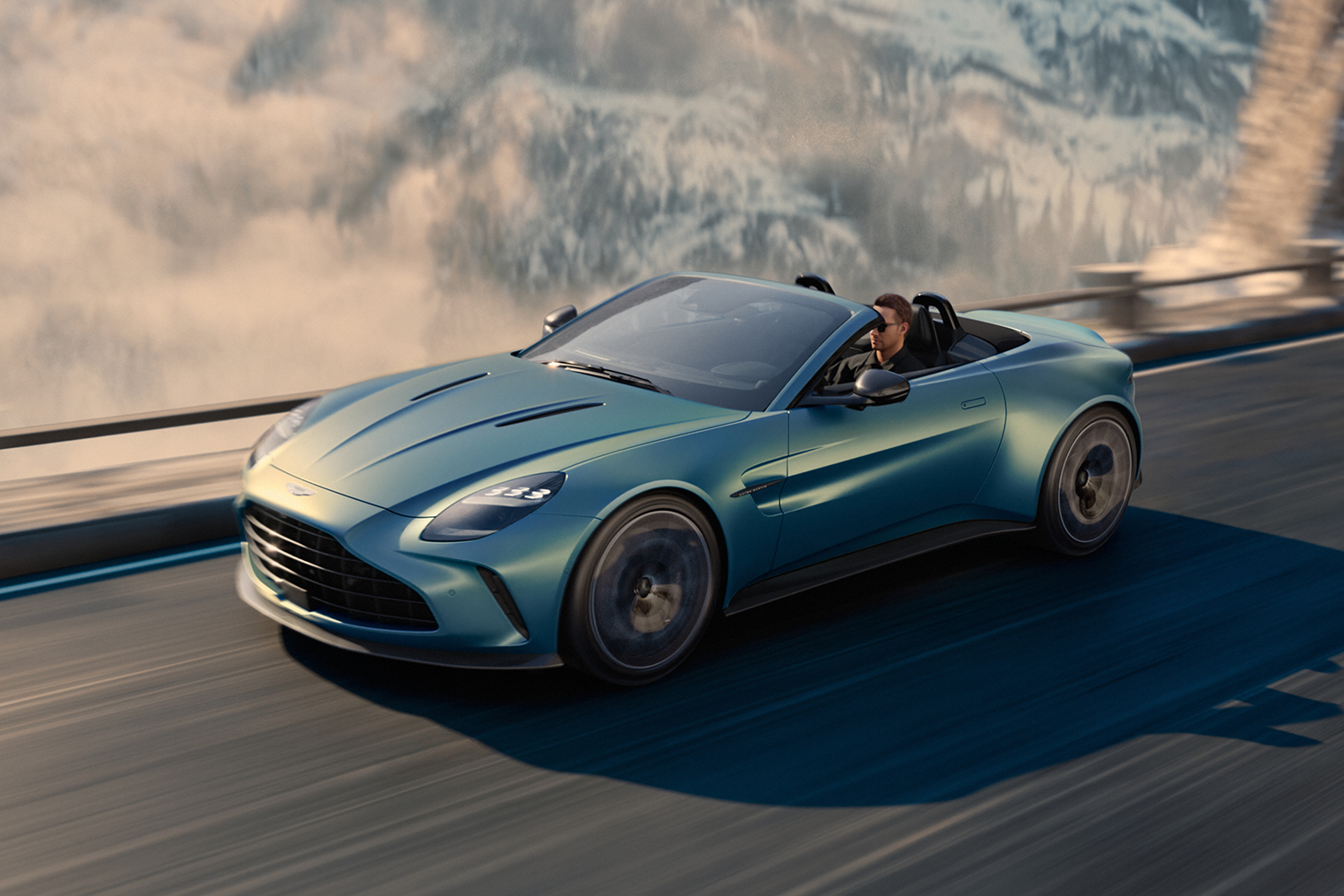 2025 Aston Martin Vantage Roadster driving down a road in the winter