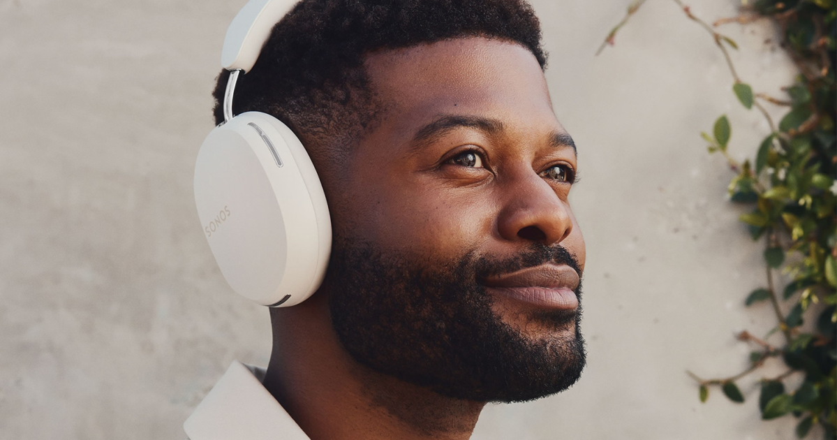 a man wearing white over-the-ear headphones