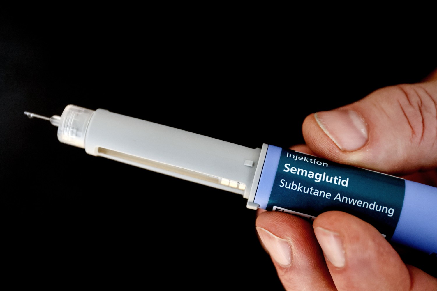 hand holding a semaglutide injector