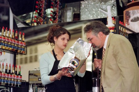 Christina Gibbs, left, of Saginaw, Michigan, holds up the brand of coffee she was using to make espresso, as Paul Songer, one of the judges, sniffs the beans, during the Torani 5th Annual Barista Cup, Saturday, May 1, 1999