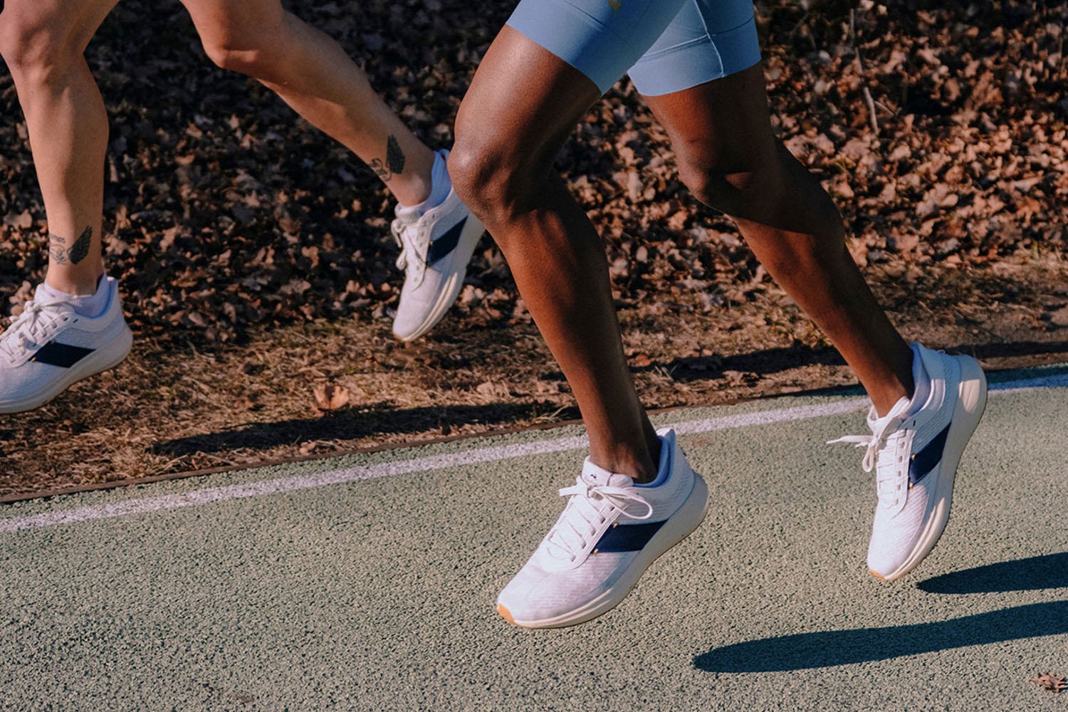 two runners jogging, shot from the thighs down