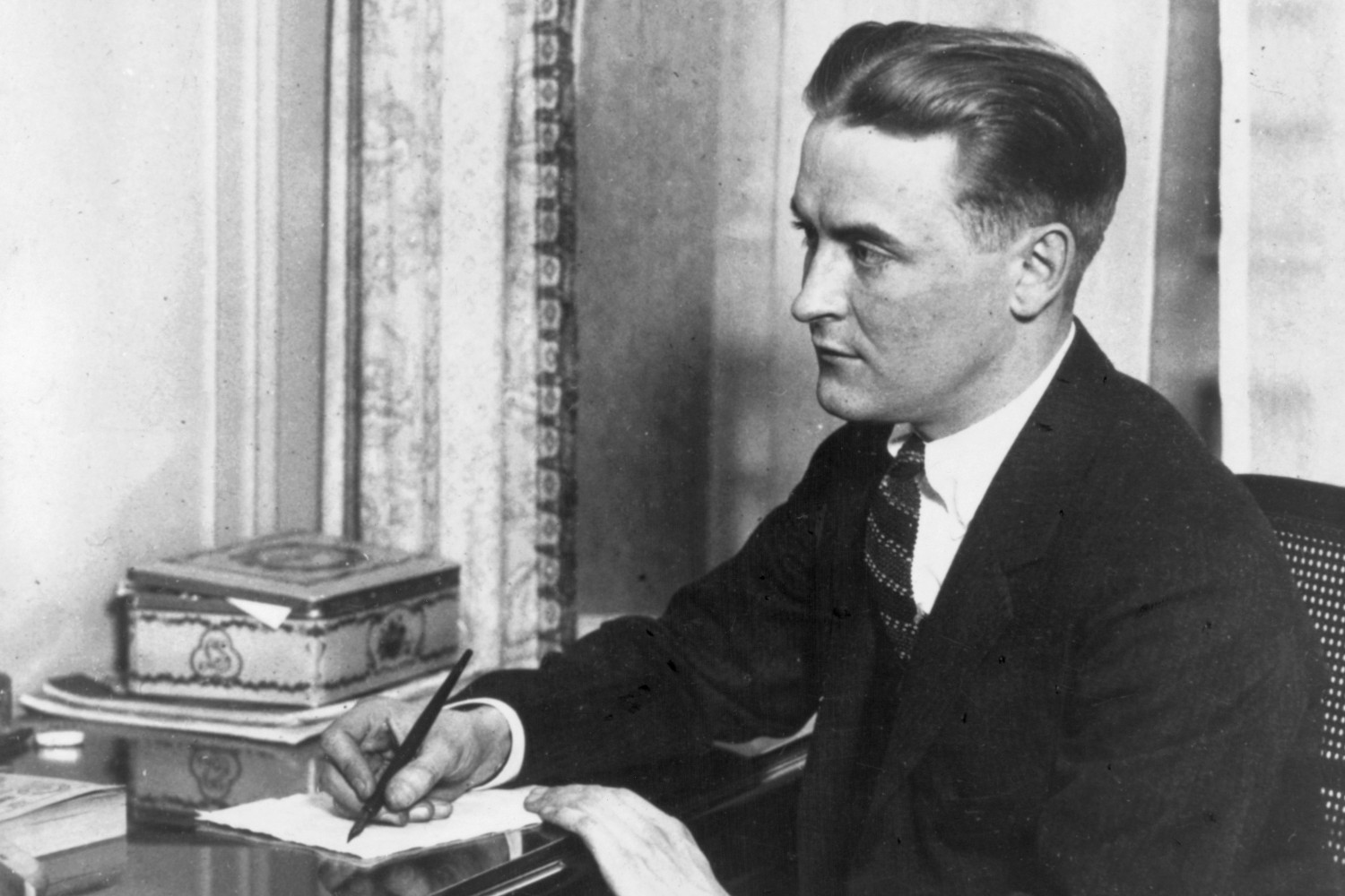 F. Scott Fitzgerald writing at a desk. A new cocktail named after the author is gaining popularity at bars across the globe.