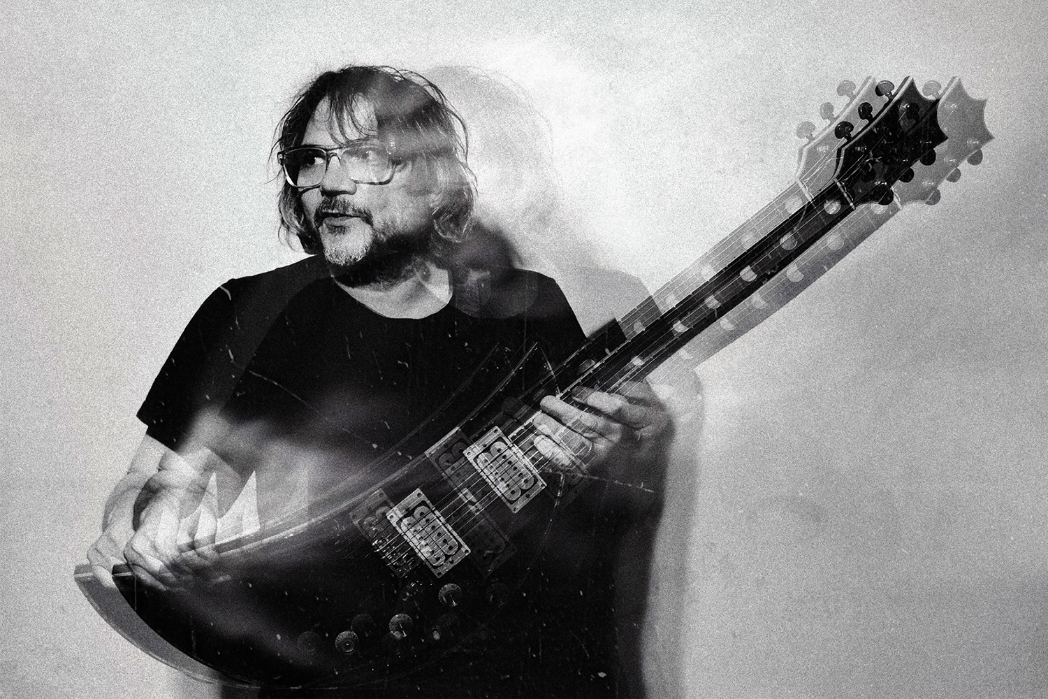 Jeff Tweedy holding a guitar in the album art for his new triple LP "Twilight Override"