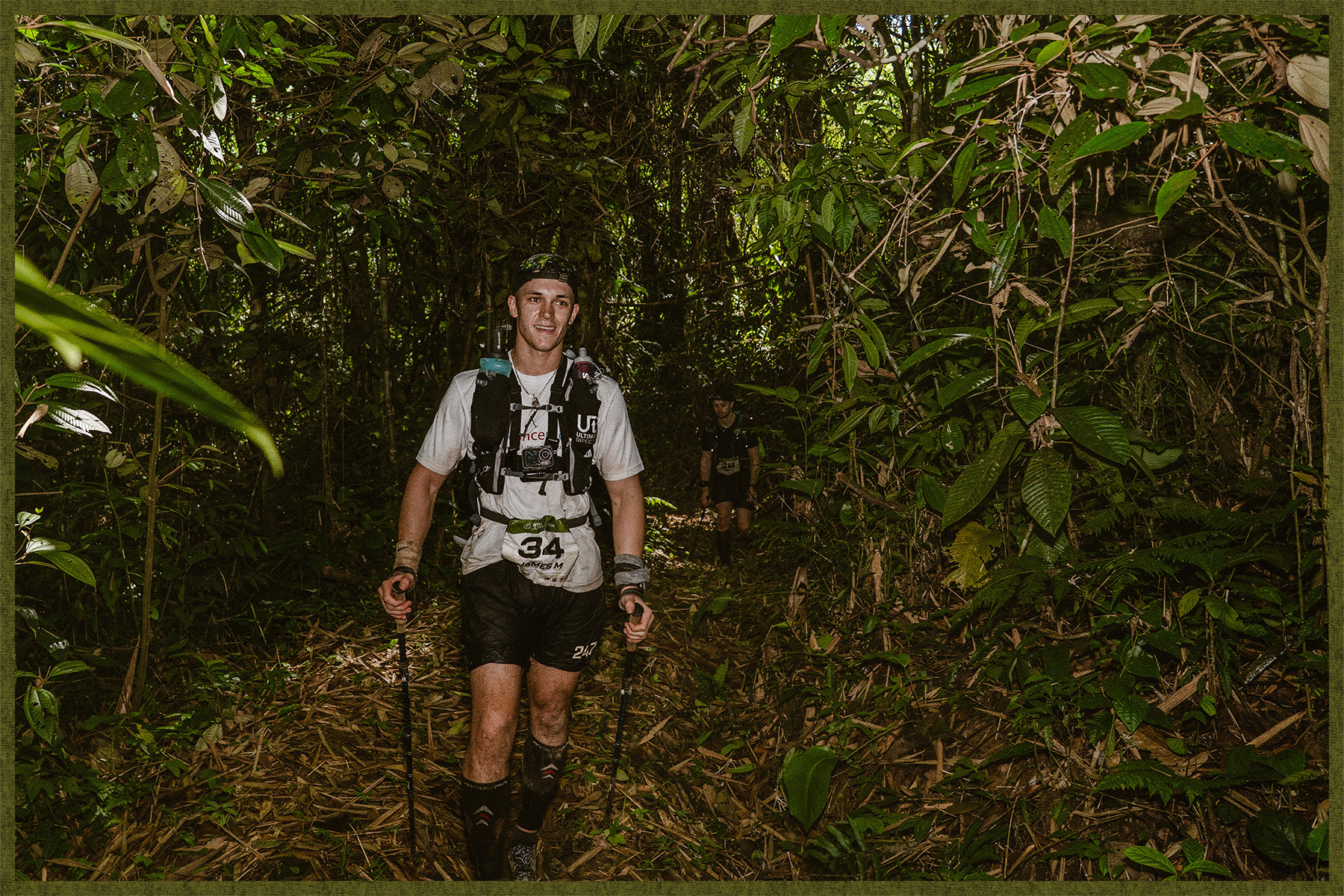 Runner trekking through dense Peruvian jungle with poles.