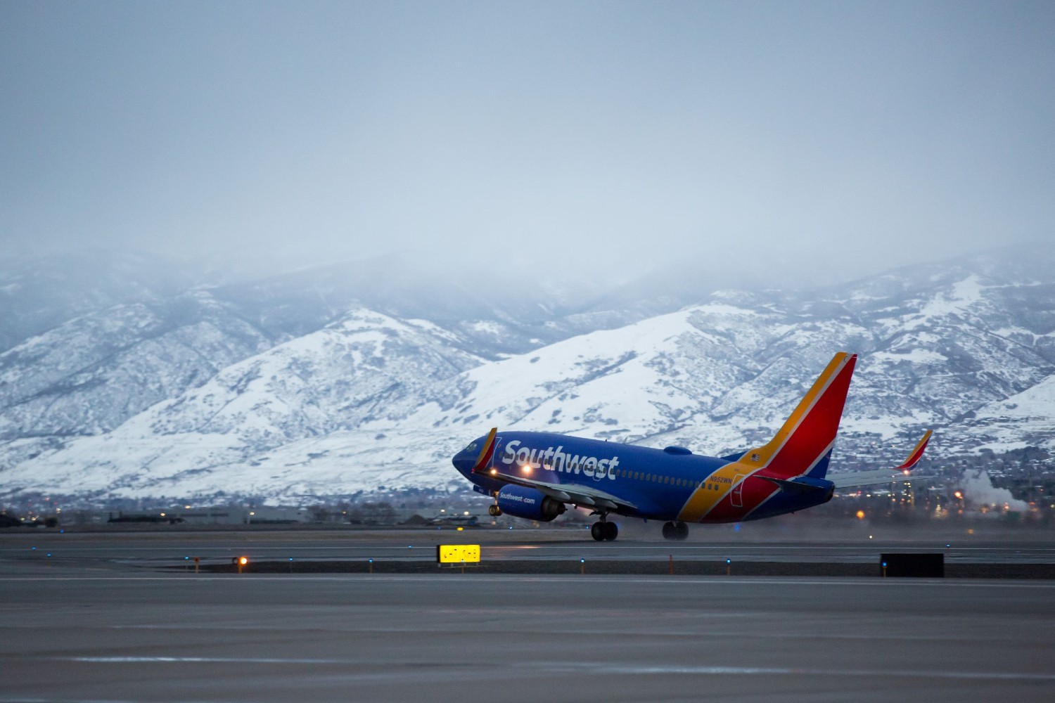 Southwest Airlines flight taking off with mountains in the background